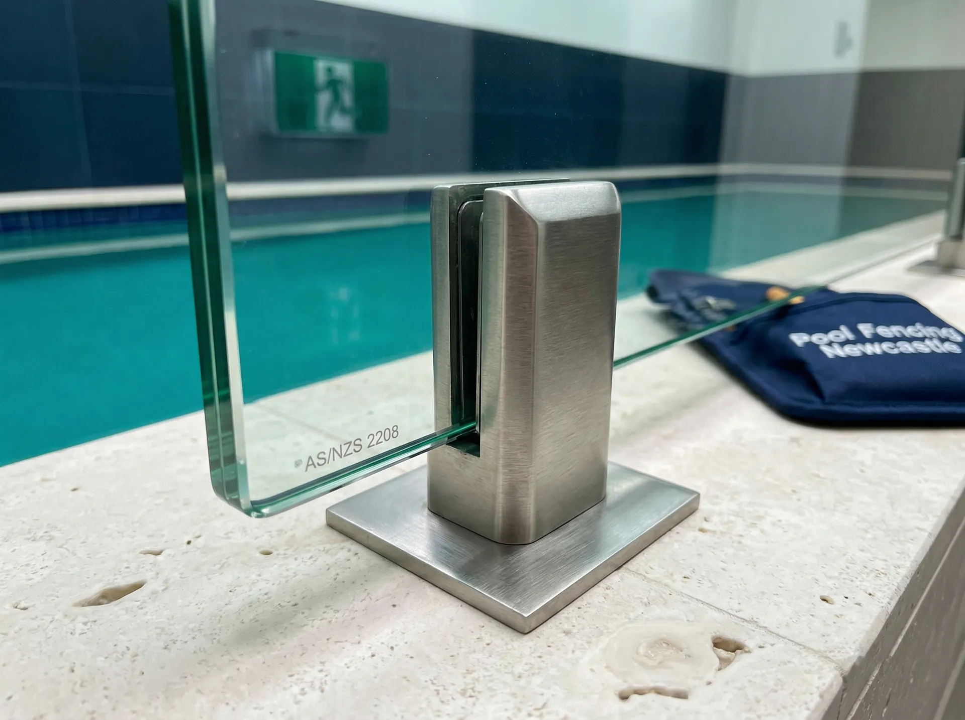 Frameless glass pool fence with stainless steel spigots